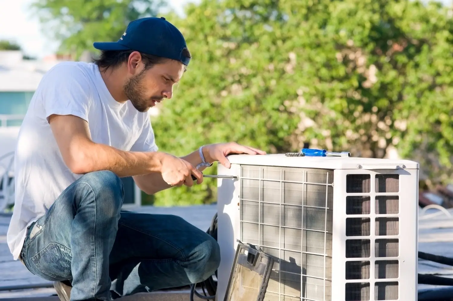 Technician working on outdoor heat pump unit.
