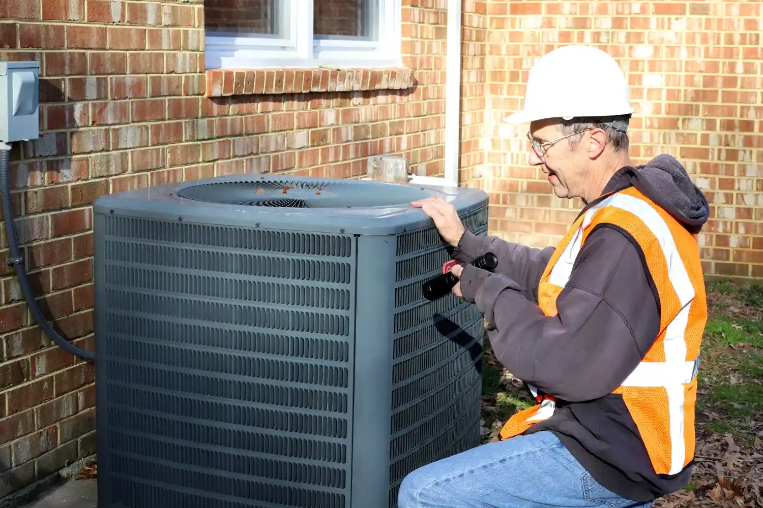 HVAC technician inspecting residential HVAC unit.