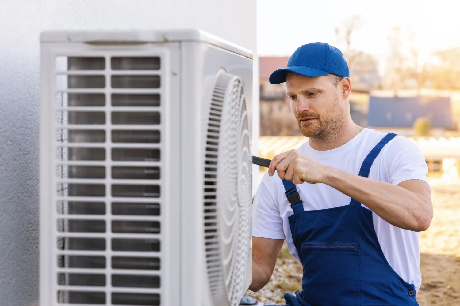 HVAC worker checking outdoor AC unit.